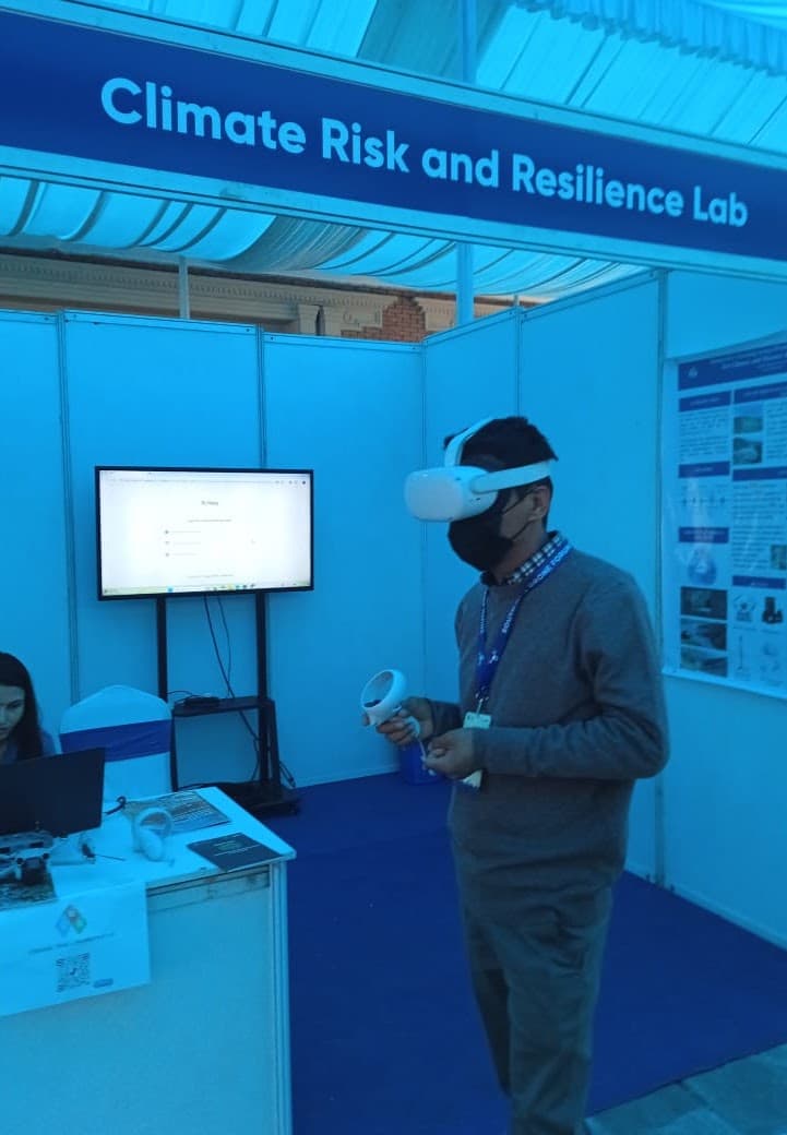Milan trying a virtual reality experience at the Climate Risk and Resilience Lab