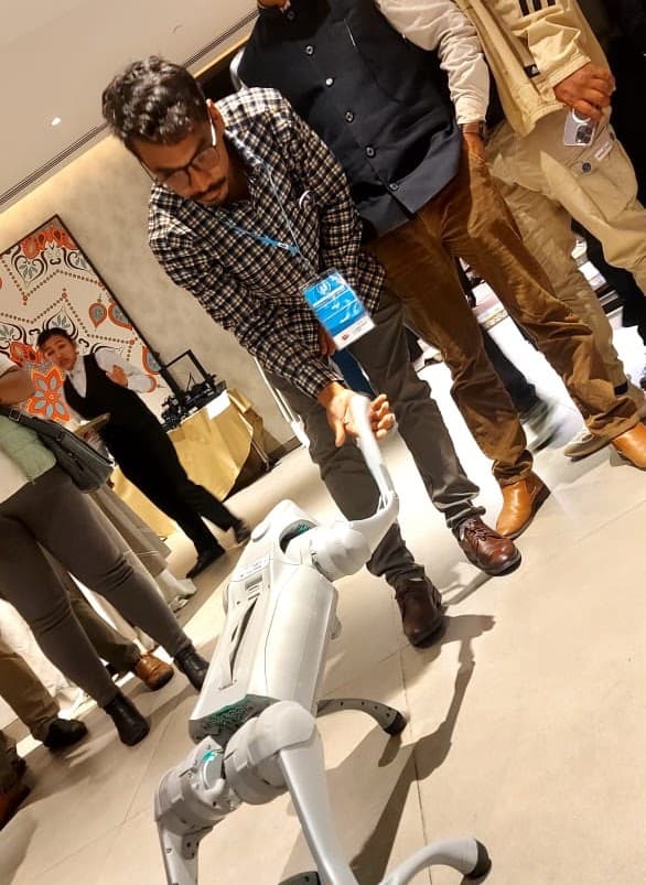 Milan exploring a robotics demonstration at an event